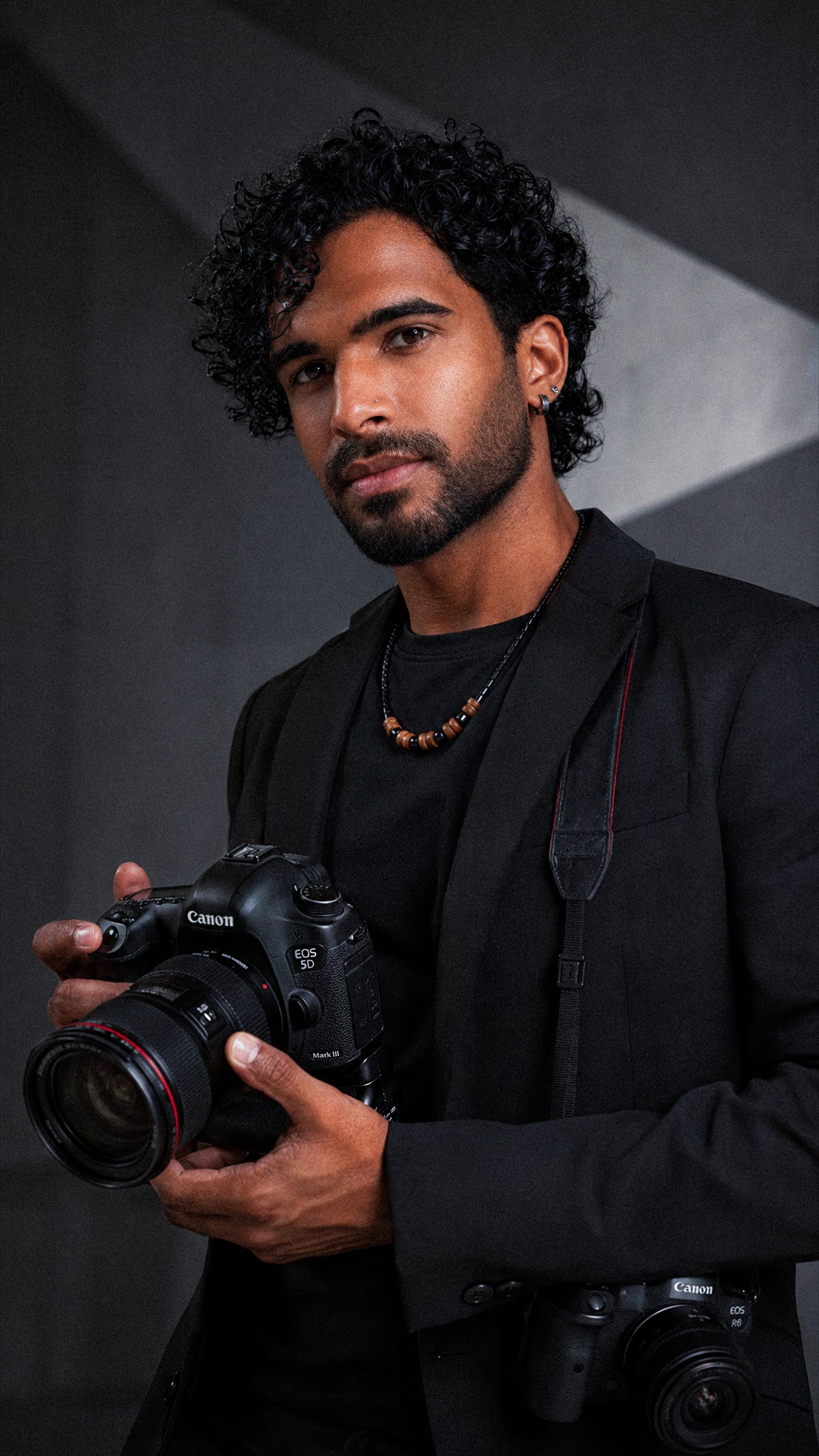 David Hawkins holding his camera in the studio