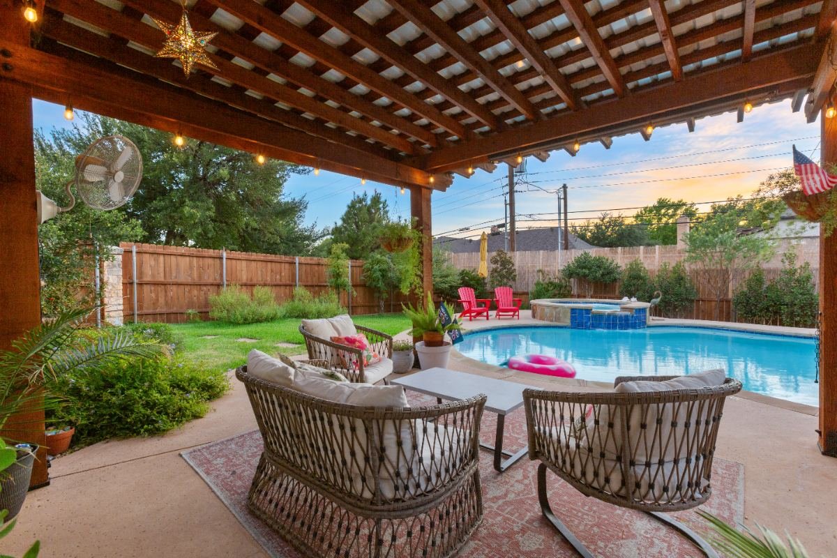 Covered patio and pool at sunset